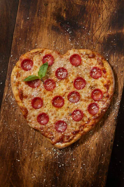 A freshly baked
        heart-shaped pepperoni pizza that looks delicious.